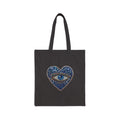 Black tote bag with evil eye graphic on a white background