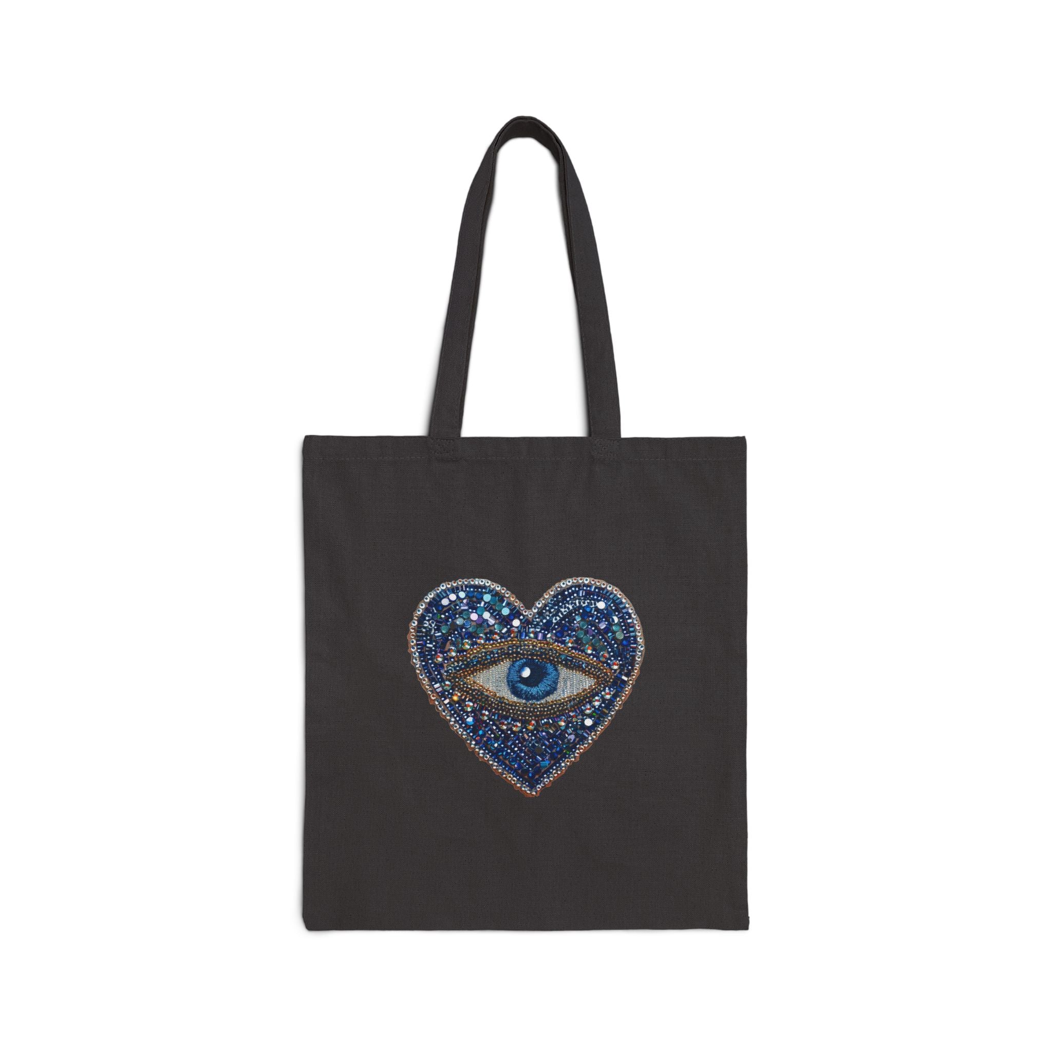 Black tote bag with evil eye graphic on a white background